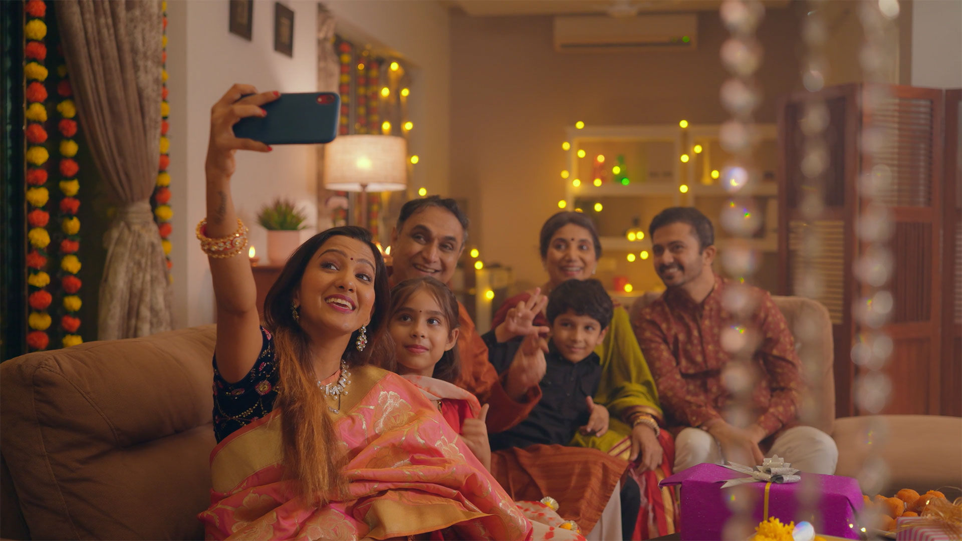 A family taking a selfie in festival attire