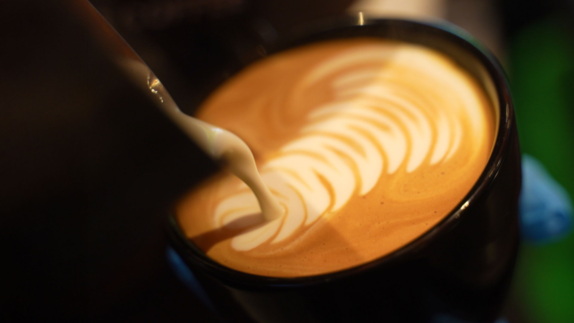 A close up of a cofee mug with coffee art